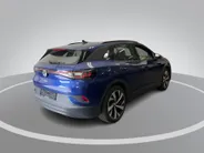 Volkswagen ID.4 Pro Business Advantage 77 kWh 204pk · SOH 95,8% · Inklap. Trekhaak · Warmtepomp · Stuur- & Stoelverwarming · 20'Velgen · ACC · Apple/Android Car Play ·