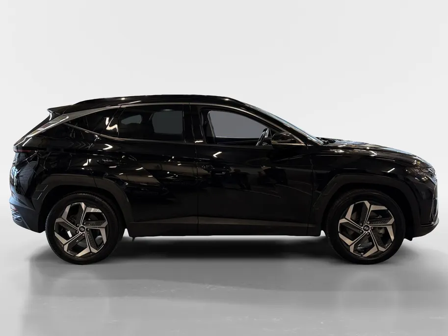 Hyundai Tucson 1.6 T-GDI PHEV Premium Sky 4WD | 66km WLTP elektrisch | Navigatie | Adaptive cruise control | Trekhaak | Apple Carplay & Android Auto | Dode hoek detectie | Draadloze telefoonlader |