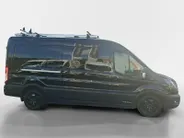 Ford Transit 350 2.0 TDCI L3H2 Trail 165 pk handgeschakeld | BPM VRIJ | Adaptive Cruise control | Navigatiesysteem | Raptor Gril | Zwarte treeplanken | LM velgen gloss black | Houten kasten links en rechts | Dakdragers met laddersysteem