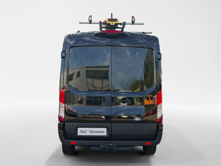 Ford Transit 350 2.0 TDCI L3H2 Trail 165 pk handgeschakeld | BPM VRIJ | Adaptive Cruise control | Navigatiesysteem | Raptor Gril | Zwarte treeplanken | LM velgen gloss black | Houten kasten links en rechts | Dakdragers met laddersysteem
